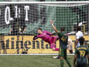 A ball kicked by Portland Timbers forward Felipe Mora (9) makes it past LA Galaxy goalkeeper Jonathan Bond (1) during the second half of an MLS soccer match, Saturday, May 22, 2021, in Portland, Ore. Portland Timbers won 3-0.