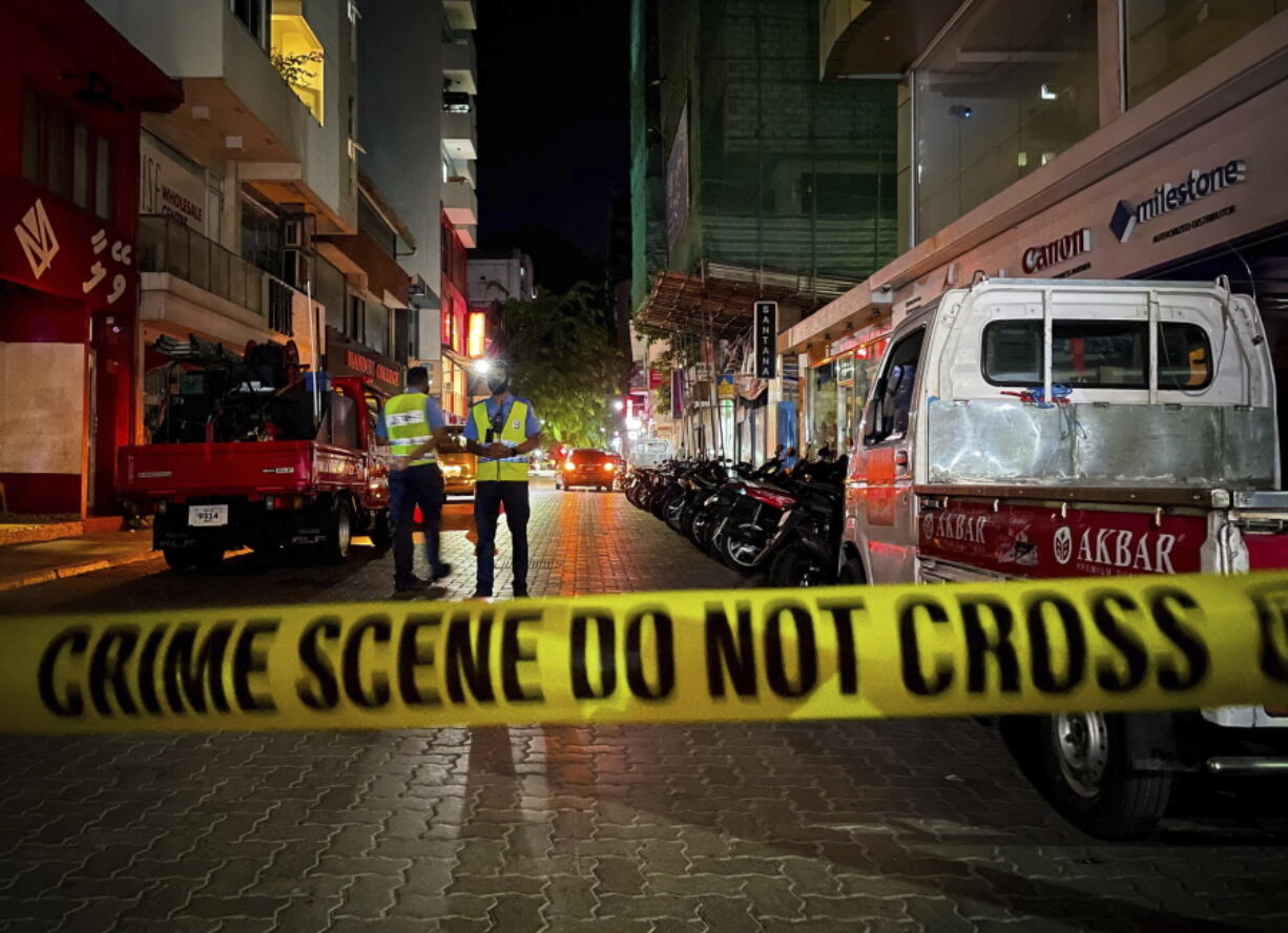 Maldivian police officers secure the area following a blast in Male, Maldives, Thursday, May 6, 2021. Maldives' first democratically elected president and current Parliament Speaker Mohamed Nasheed has been injured in a blast Thursday near his home and was being treated in a hospital in the capital, police said.