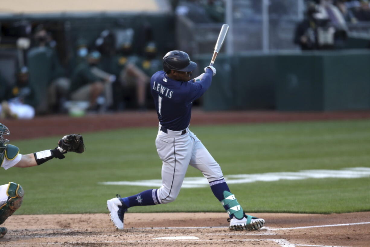 Seattle Mariners' Kyle Lewis hits a two-run home run against the Oakland Athletics during the third inning of a baseball game in Oakland, Calif., Monday, May 24, 2021.