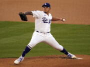 Los Angeles Dodgers starting pitcher Julio Urias throws to a Seattle Mariners batter during the first inning of a baseball game Wednesday, May 12, 2021, in Los Angeles.