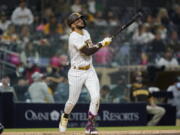 San Diego Padres' Fernando Tatis Jr. watches his three-run home run during the second inning of the team's baseball game against the Seattle Mariners, Friday, May 21, 2021, in San Diego.