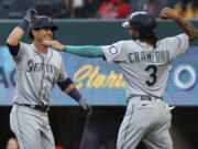 Seattle Mariners' Dylan Moore (25) celebrates his two-run home run with J.P. Crawford (3) during the second inning against the Texas Rangers in a baseball game Friday, May 7, 2021, in Arlington, Texas. (AP Photo/Richard W.