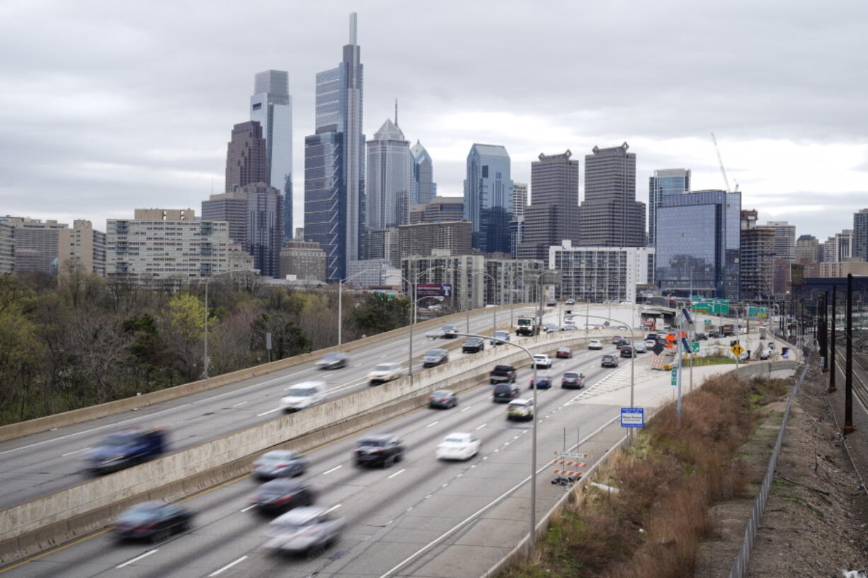 FILE - In this March 31, 2021 file photo, traffic moves along the Interstate 76 highway in Philadelphia.  If you're traveling over the Memorial Day weekend, expect lots of company. The AAA auto club said Tuesday, May 11,  that more than 37 million Americans plan to travel at least 50 miles from home over the holiday weekend.