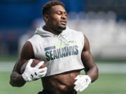 FILE - Seattle Seahawks wide receiver DK Metcalf runs with the ball during warmups before an NFL football game against the Dallas Cowboys in Seattle, in this Sunday, Sept. 27, 2020, file photo. Metcalf has accepted an invitation to run the 100 meters at the USA Track and Field Golden Games in Walnut, California.