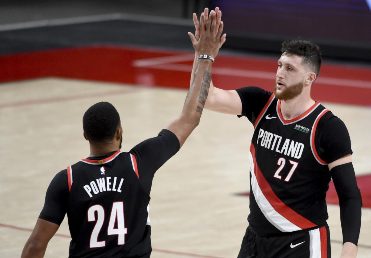 Portland Trail Blazers forward Norman Powell, left, celebrates with center Jusuf Nurkic, right, during the second half of Game 4 of an NBA basketball first-round playoff series against the Denver Nuggets in Portland, Ore., Saturday, May 29, 2021. The Blazers won 1115-95.