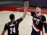 Portland Trail Blazers forward Norman Powell, left, celebrates with center Jusuf Nurkic, right, during the second half of Game 4 of an NBA basketball first-round playoff series against the Denver Nuggets in Portland, Ore., Saturday, May 29, 2021. The Blazers won 1115-95.