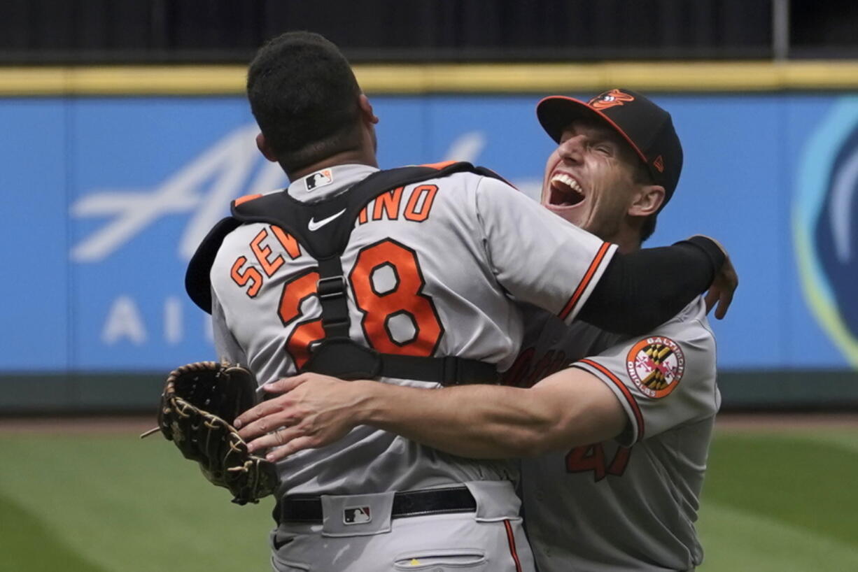 Baltimore Orioles starting pitcher John Means, right, hugs catcher Pedro Severino after Means threw a no-hitter in the team's baseball game against the Seattle Mariners, Wednesday, May 5, 2021, in Seattle. The Orioles won 6-0. (AP Photo/Ted S.