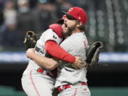 Cincinnati Reds starting pitcher Wade Miley, right, is congratulated by catcher Tucker Barnhart after pitching a no-hitter against the Cleveland Indians in a baseball game, Friday, May 7, 2021, in Cleveland.