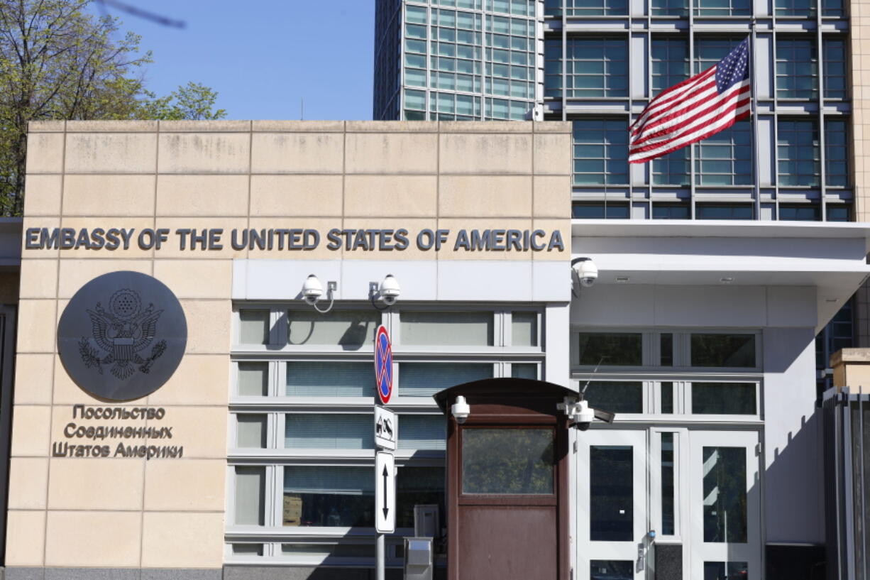 The U.S. Embassy and the National flag are seen in Moscow, Russia, Tuesday, May 11, 2021. Under Kremlin orders, the U.S. Embassy has stopped employing Russians, leaving Russian businessmen, lovers and exchange students adrift because they can't get visas and American parents unable to register their newborns as citizens.