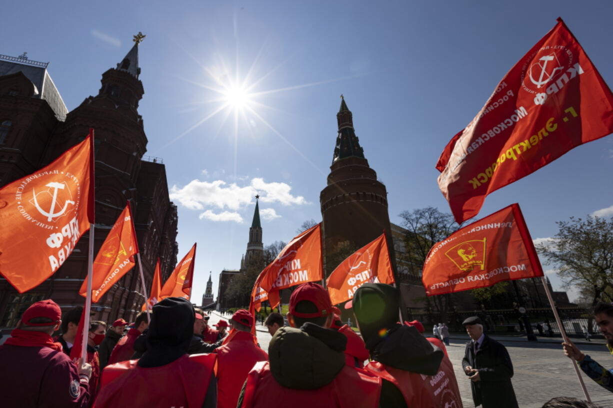 Communists party supporters gather with red flags to mark Labour Day, also knows as May Day near Red Square in Moscow, Russia, Saturday, May 1, 2021.