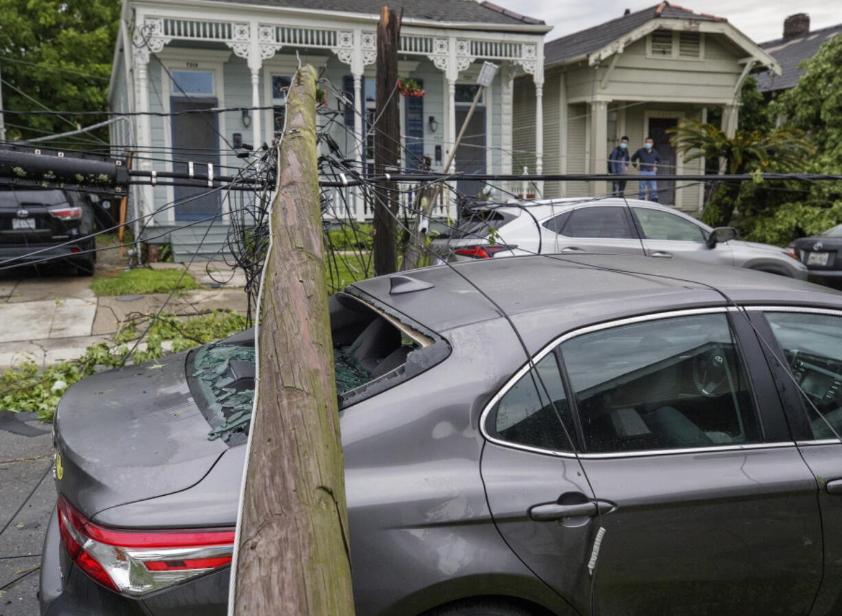 A utility pole rests on a 2020 Toyota Camry smashing the back window after powerful storms rolled through the city overnight, in New Orleans Wednesday, May 12, 2021.