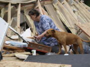 Vickie Savell looks through her belongings amid the remains of her new mobile home early Monday, May 3, 2021, in Yazoo County, Miss. Multiple tornadoes were reported across Mississippi on Sunday, causing some damage but no immediate word of injuries. (AP Photo/Rogelio V.