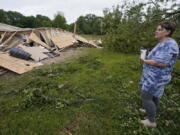 Vickie Savell looks at the remains of her new mobile home early Monday, May 3, 2021, in Yazoo County, Miss. Multiple tornadoes were reported across Mississippi on Sunday, causing some damage but no immediate word of injuries. (AP Photo/Rogelio V.