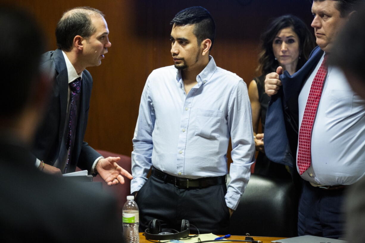 Cristhian Bahena Rivera speaks to court interpreter Steven Rhodes during Bahena Rivera's trial, Wednesday, May 26, 2021, in the Scott County Courthouse in Davenport, Iowa. Bahena Rivera is on trial for the 2018 stabbing death of Mollie Tibbetts, a University of Iowa student.