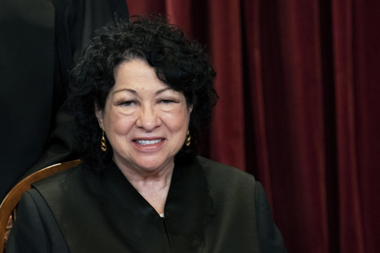 Associate Justice Sonia Sotomayor sits during a group photo at the Supreme Court in Washington, Friday, April 23, 2021.