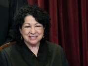 Associate Justice Sonia Sotomayor sits during a group photo at the Supreme Court in Washington, Friday, April 23, 2021.