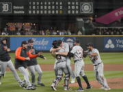 Detroit Tigers starting pitcher Spencer Turnbull, center right, hugs catcher Eric Haase as teammates rush in after Turnbull threw a no-hitter against the Seattle Mariners in a baseball game Tuesday, May 18, 2021, in Seattle. The Tigers won 5-0. (AP Photo/Ted S.