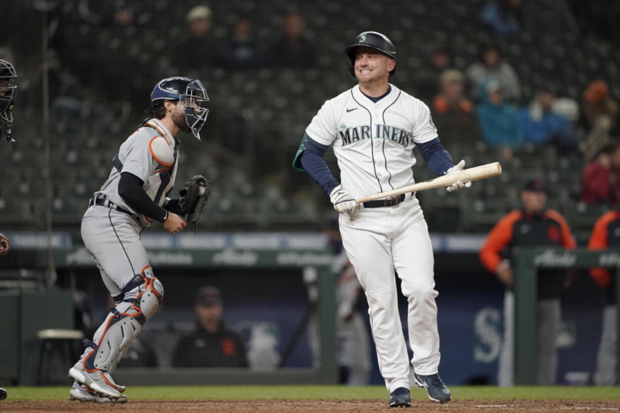 Seattle Mariners' Kyle Seager, right, reacts after striking out swinging with two men on base as Detroit Tigers catcher Eric Haase, left holds the ball during the eighth inning of a baseball game Wednesday, May 19, 2021, in Seattle. (AP Photo/Ted S.