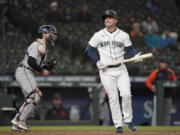 Seattle Mariners' Kyle Seager, right, reacts after striking out swinging with two men on base as Detroit Tigers catcher Eric Haase, left holds the ball during the eighth inning of a baseball game Wednesday, May 19, 2021, in Seattle. (AP Photo/Ted S.