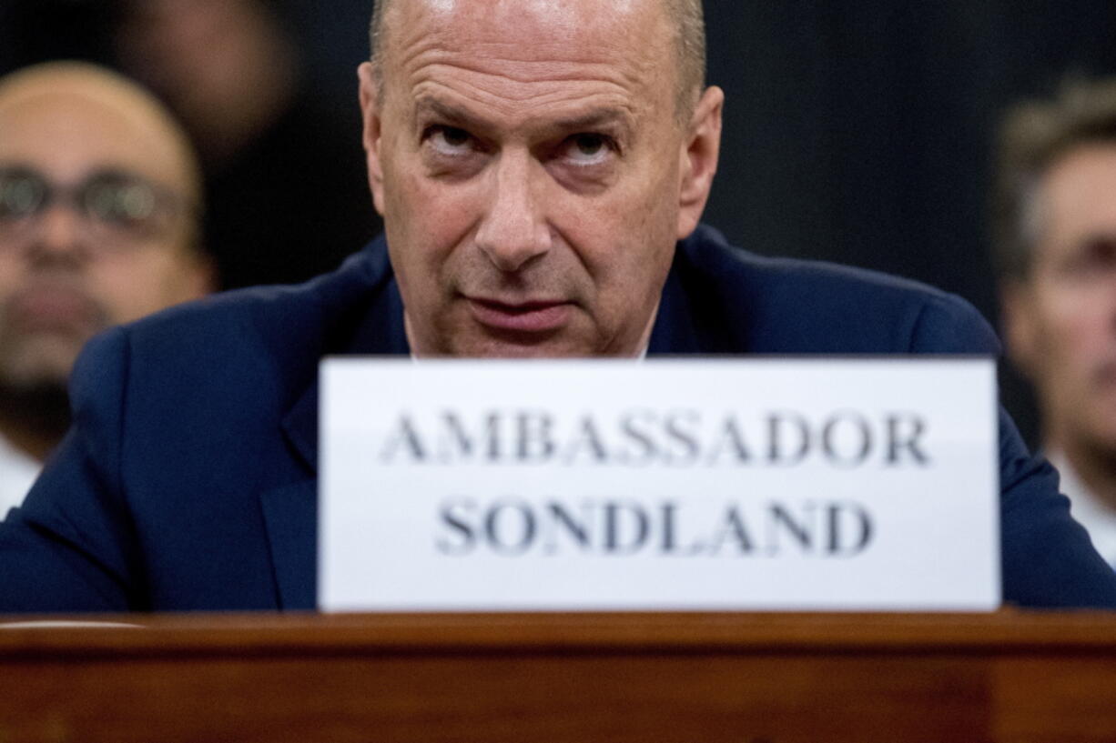 FILE - In this Nov. 20, 2019 file photo, then Ambassador Gordon Sondland, U.S. Ambassador to the European Union, center, appears before the House Intelligence Committee on Capitol Hill in Washington. The Trump administration's ambassador to the European Union and a pivotal witness in 2019 impeachment proceedings has sued former Secretary of State Mike Pompeo in an effort to recoup $1.8 million in legal fees.