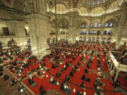 Muslims offer prayers during the first day of Eid al-Fitr, which marks the end of the holy month of Ramadan at Fatih Mosque in Istanbul, Thursday, May 13, 2021. Hundreds of Muslims attended dawn Eid al-Fitr prayers Thursday marking the end of the month of prayer and fasting for Muslims around the world, a usually joyous three-day celebration that has been significantly toned down as coronavirus cases soar.