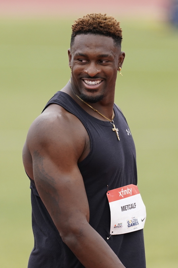 Seattle Seahawks wide receiver DK Metcalf smiles after competing in the second heat of the men's 100-meter dash prelim during the USATF Golden Games at Mt. San Antonio College Sunday, May 9, 2021, in Walnut, Calif.