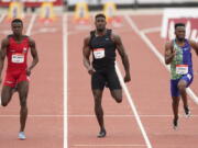 Seattle Seahawks wide receiver DK Metcalf, center, competes in the second heat of the men's 100-meter dash prelim during the USATF Golden Games at Mt. San Antonio College Sunday, May 9, 2021, in Walnut, Calif. At left is Felipe Bardi Dos Santos and at right is Abdullah Mohammed.