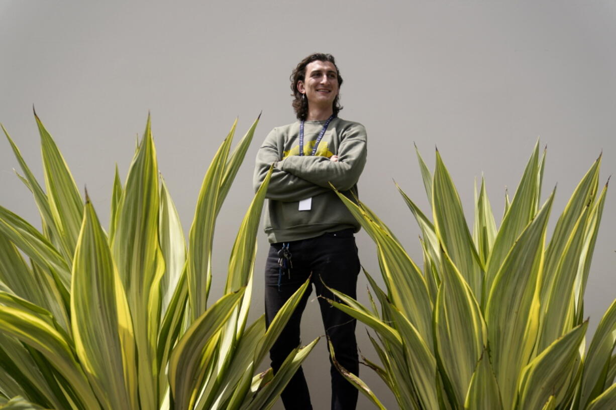 Lucius Giannini stands for a portrait Thursday, April 15, 2021, in San Diego. Giannini graduated from the University of California at San Diego at the end of last summer with a degree in political science. He had hoped to find work with the Peace Corps, or maybe teaching English overseas. But the Peace Corps was bringing all its volunteers home, and no one was hiring for overseas teaching.