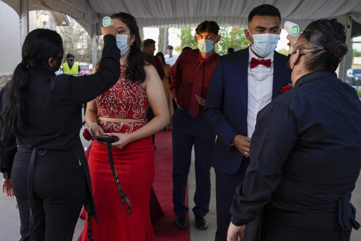 Grace Gardens Event Center employees check temperatures of young people attending prom at the Grace Gardens Event Center in El Paso, Texas on Friday, May 7, 2021. Around 2,000 attended the outdoor event at the private venue after local school districts announced they would not host proms this year. Tickets cost $45.