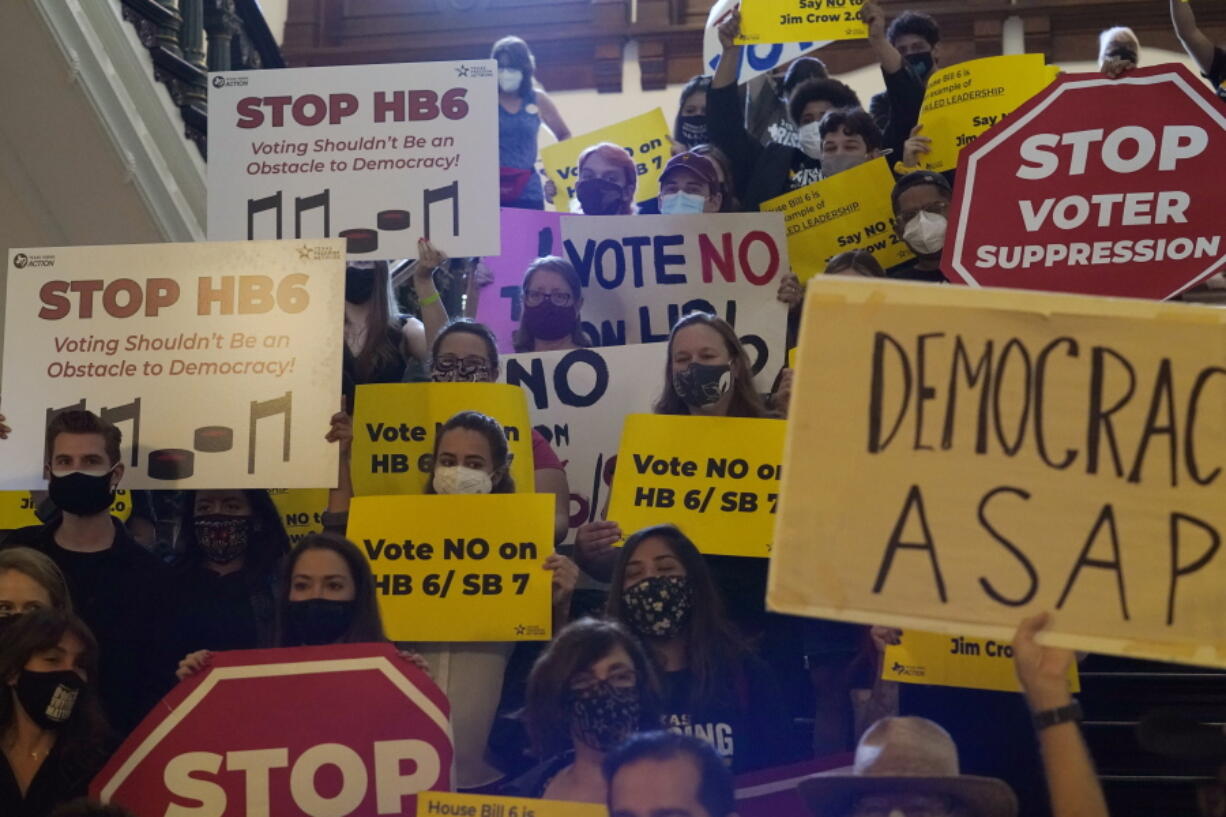 FILE - In this May 6, 2021 file photo, a group opposing new voter legislation gather outside the House Chamber at the Texas Capitol in Austin, Texas.