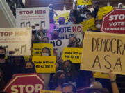 FILE - In this May 6, 2021 file photo, a group opposing new voter legislation gather outside the House Chamber at the Texas Capitol in Austin, Texas.