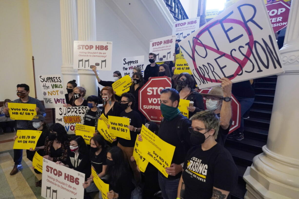 FILE - In this May 6, 2021, file photo, a group opposing new voter legislation gather outside the House Chamber at the Texas Capitol in Austin, Texas. In 2020, election officials tried to make voting easier and safer amid a global pandemic. Next time, they might get fined or face criminal charges.