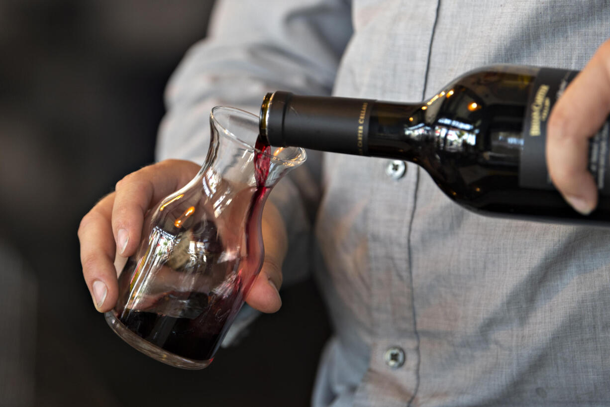 Tasting room associate Theo Squires serves a customer at Brian Carter Cellars at The Waterfront Vancouver on Tuesday afternoon, May 4, 2021.