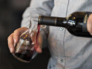 Tasting room associate Theo Squires serves a customer at Brian Carter Cellars at The Waterfront Vancouver on Tuesday afternoon, May 4, 2021.