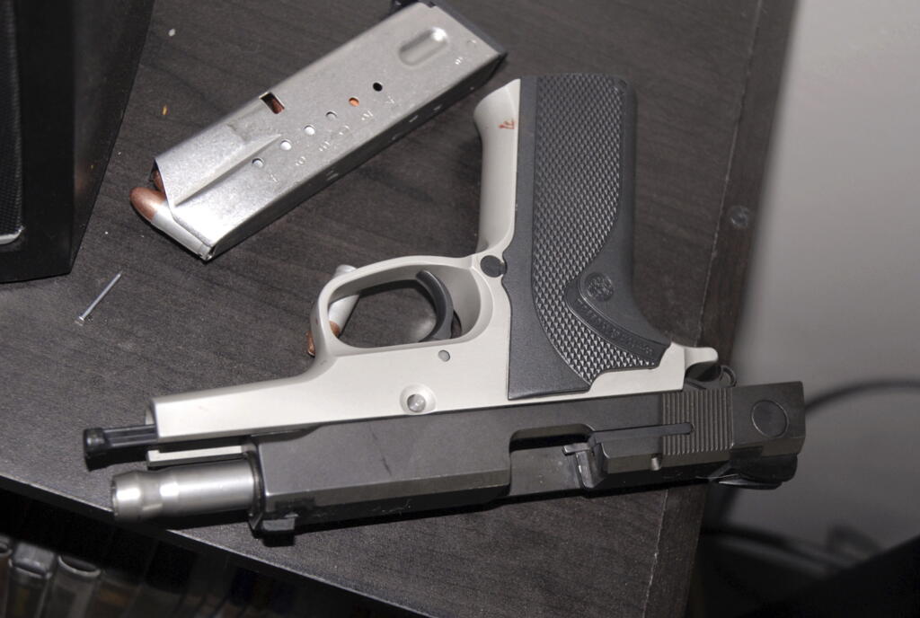 A Smith &amp; Wesson 9-mm pistol on a table in the apartment where Kyle Juhl used it to kill himself in Yakima. The pistol that Juhl used to kill himself was familiar to law enforcement: The Washington State Patrol had seized it years earlier while investigating a crime and then arranged its sale back to the public. It eventually fell into Juhl's hands, illegally.