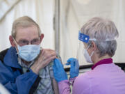 Vancouver resident Dennis Marlowe gets his second vaccination dose from Safeway pharmacist Kristen Morin at the Tower Mall vaccination site in Vancouver on April 5. Vaccinations are available without an appointment at the site, which will close June 29.