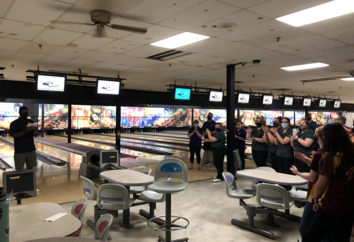 Bowlers applaud during an awards ceremony after the 4A/3A district championships on Wednesday at Crosley Lanes in Vancouver.