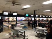 Bowlers applaud during an awards ceremony after the 4A/3A district championships on Wednesday at Crosley Lanes in Vancouver.