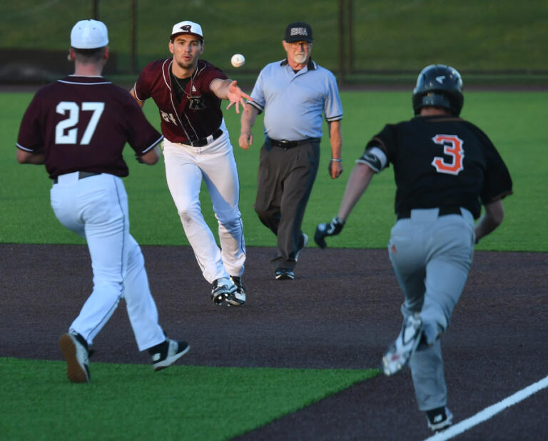 Ridgefield first baseman Will Chambers, center, tosses the ball to pitcher Andrew Troppmann, left, so he can get Cowlitz infielder Brock Bozett out Wednesday, June 2, 2021, during the Ridgefield Raptors' 10-8 loss to the Cowlitz Black Bears at the Ridgefield Outdoor Recreation Complex.