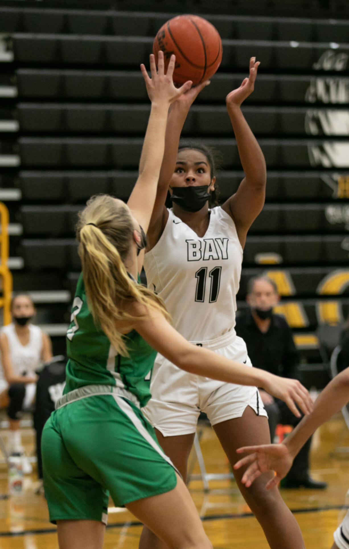 Hudson's Bay forward Jaydia Martin (11) takes a shot while being defended by Tumwater guard Aubrey Amendala (12) during the fourth quarter of the 2A district semi-final game at Hudson's Bay High School on Wednesday, June 9, 2021. Tumwater went on to win by of a score of 61-45.