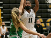 Hudson's Bay forward Jaydia Martin (11) takes a shot while being defended by Tumwater guard Aubrey Amendala (12) during the fourth quarter of the 2A district semi-final game at Hudson's Bay High School on Wednesday, June 9, 2021. Tumwater went on to win by of a score of 61-45.