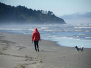 Beachgoers stroll on the sand in Seaview, on Washington's Long Beach peninsula.