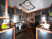 Black cabinets trimmed in walnut make an elegant statement in this kitchen.