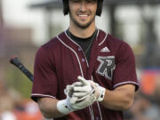 Ridgefield's Will Chambers takes off his elbow guard as a new Portland Pickles pitcher warms up in a West Coast League baseball game on Tuesday, June 8, 2021, at the Ridgefield Outdoor Recration Complex. Ridgefield won 6-3 to improve to 4-0 on the season.