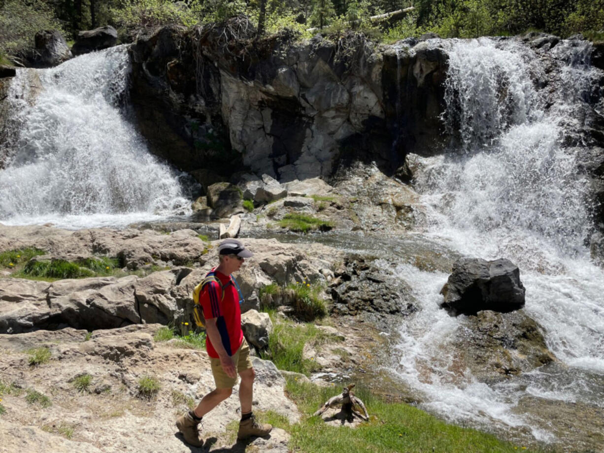 Bend???s Mark Johnson takes in the scenery near a double waterfall along Paulina Creek.