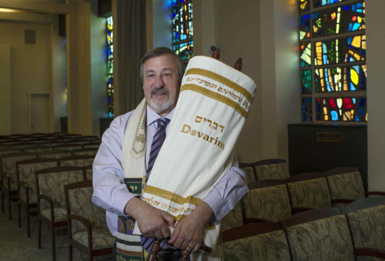 Rabbi Leonard Sarko, of Congregation Emanu-El Israel, holds a Sefer Torah done in braille June 8 at the Congregation Emanu-El Israel in Greensburg, Pa.