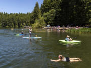 Swimmers, kayakers and stand-up paddleboarders enjoy an afternoon on the water Saturday at Battle Ground Lake State Park.