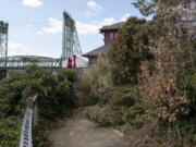 The current boardwalk ends at a locked gate and shrubbery behind Who Song and Larry's.(Joshua Hart/The Columbian)