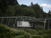 A truck traveling south on Interstate 5 approaches the twin bridges that carry the freeway over the North Fork Lewis River.