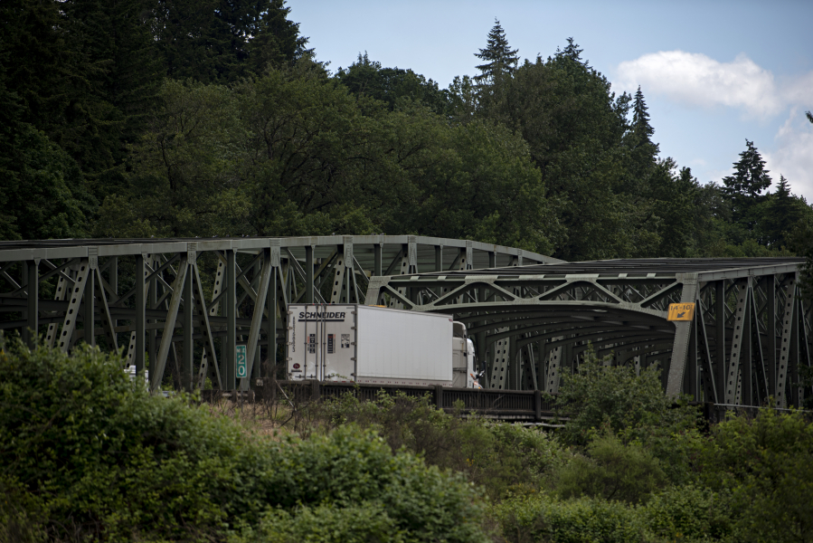 A truck traveling south on Interstate 5 approaches the twin bridges that carry the freeway over the North Fork Lewis River.